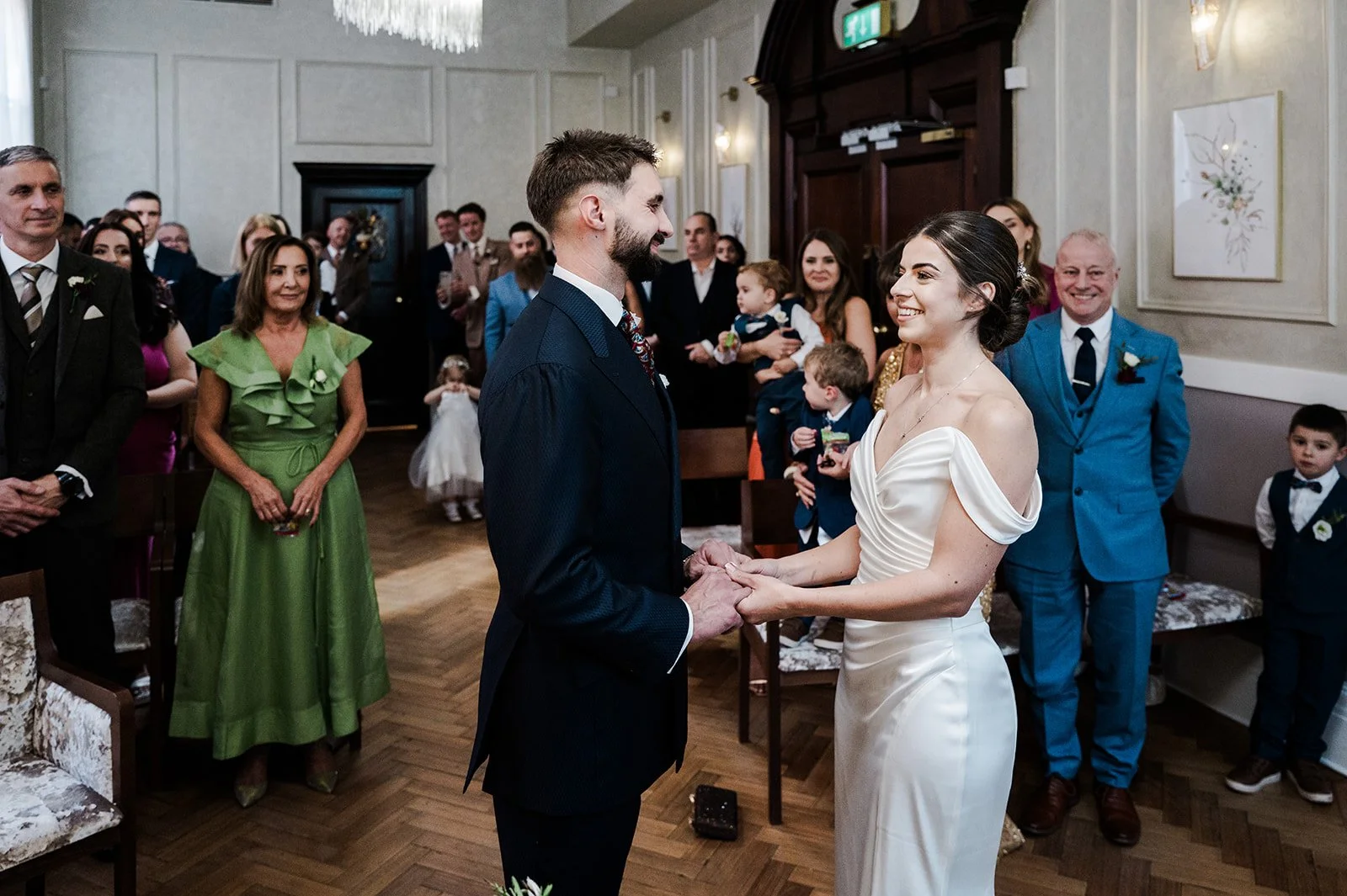 A couple exchanging vows during their wedding ceremony at Chelsea Old Town Hall