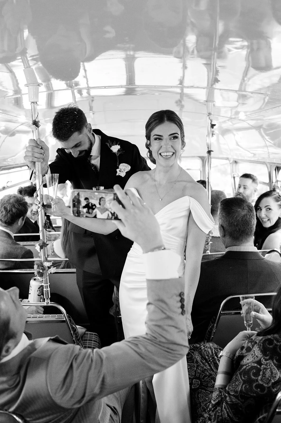 Nat and Josh celebrating on the Routemaster bus with their guests
