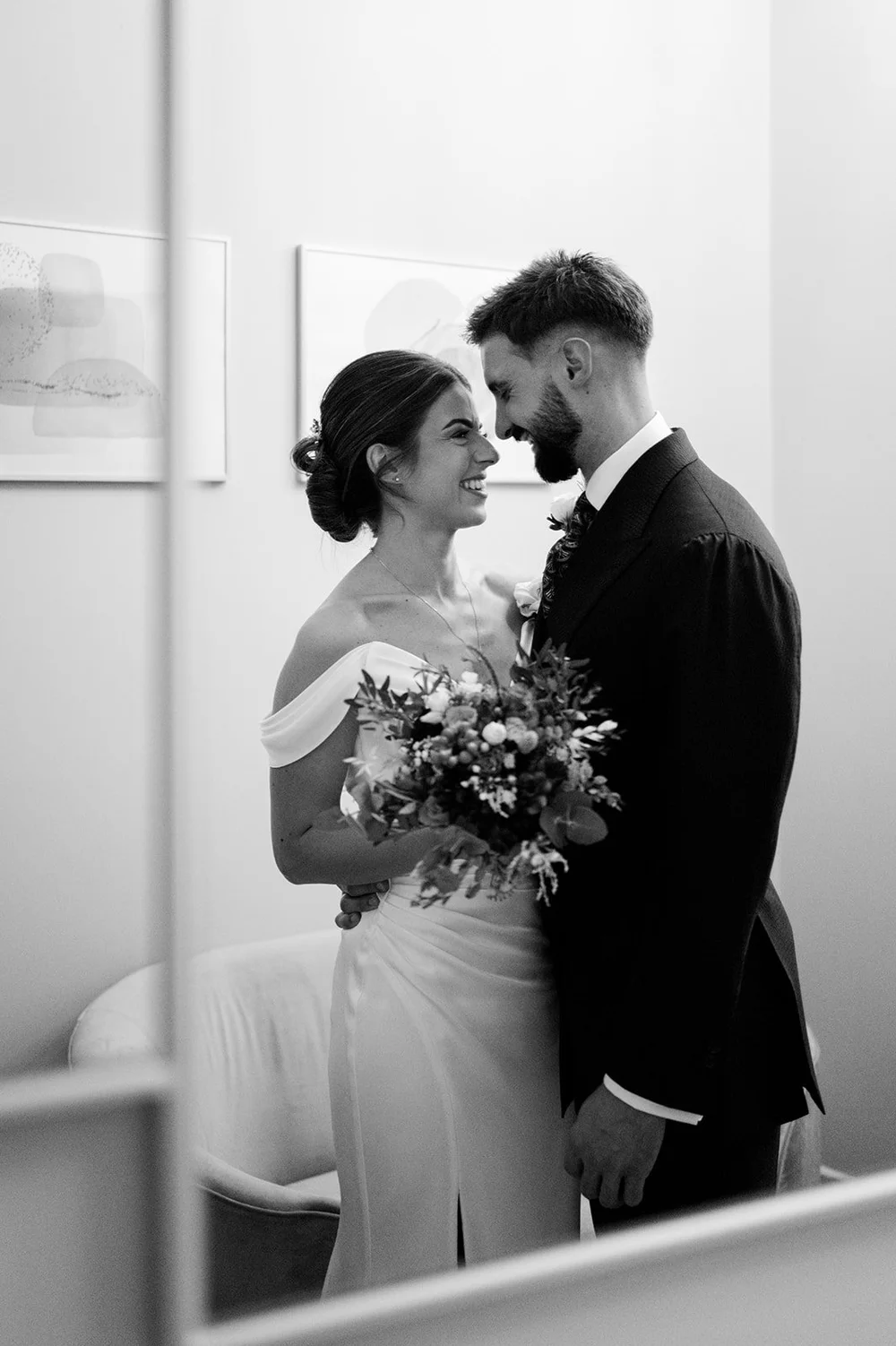 Black and white portrait of a couple by the window at Chelsea Old Town Hall