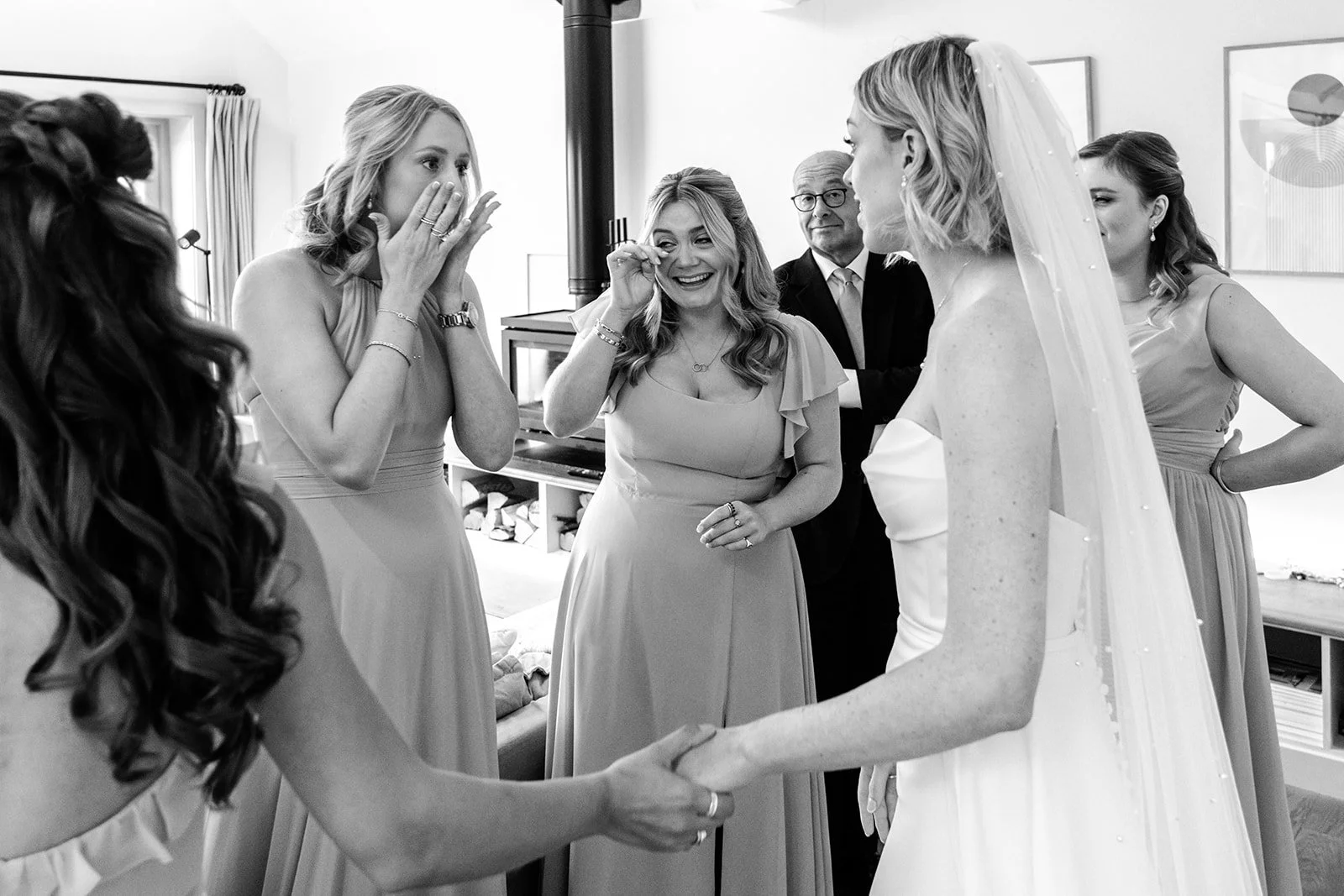 Emotional bridal reveal at Limekiln — bridesmaids and family overcome with emotion seeing Abi in her wedding dress, black and white