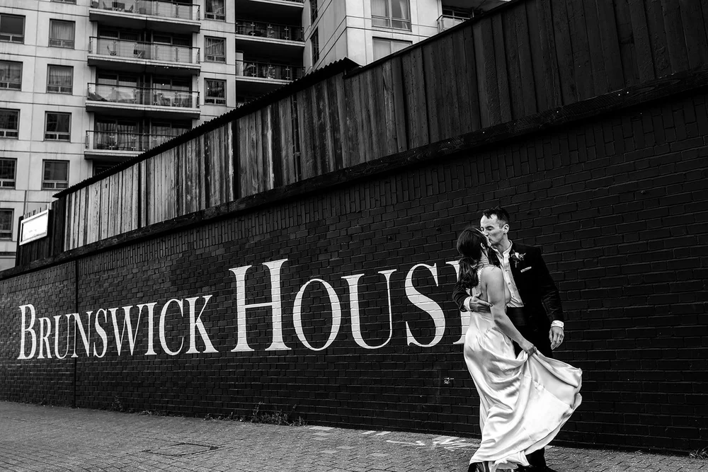 Wedding couple in front of the Brunswick House painted sign, Vauxhall, Oliver Holder Photography