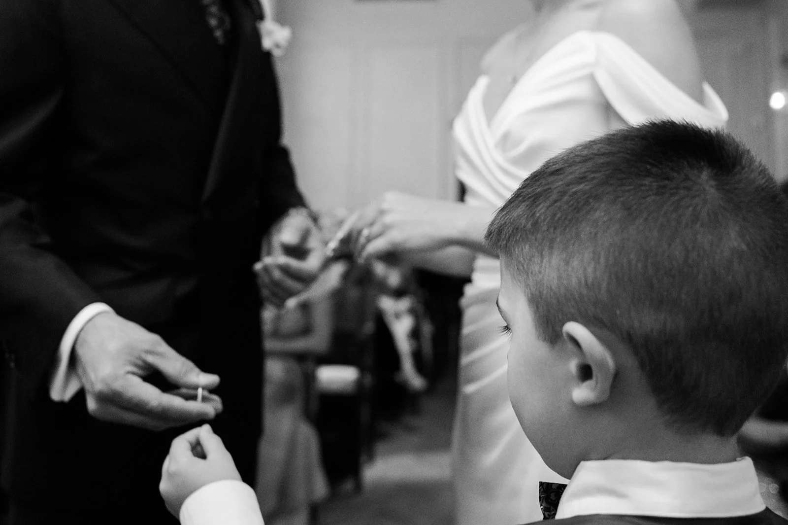 Ring exchange with their son watching closely