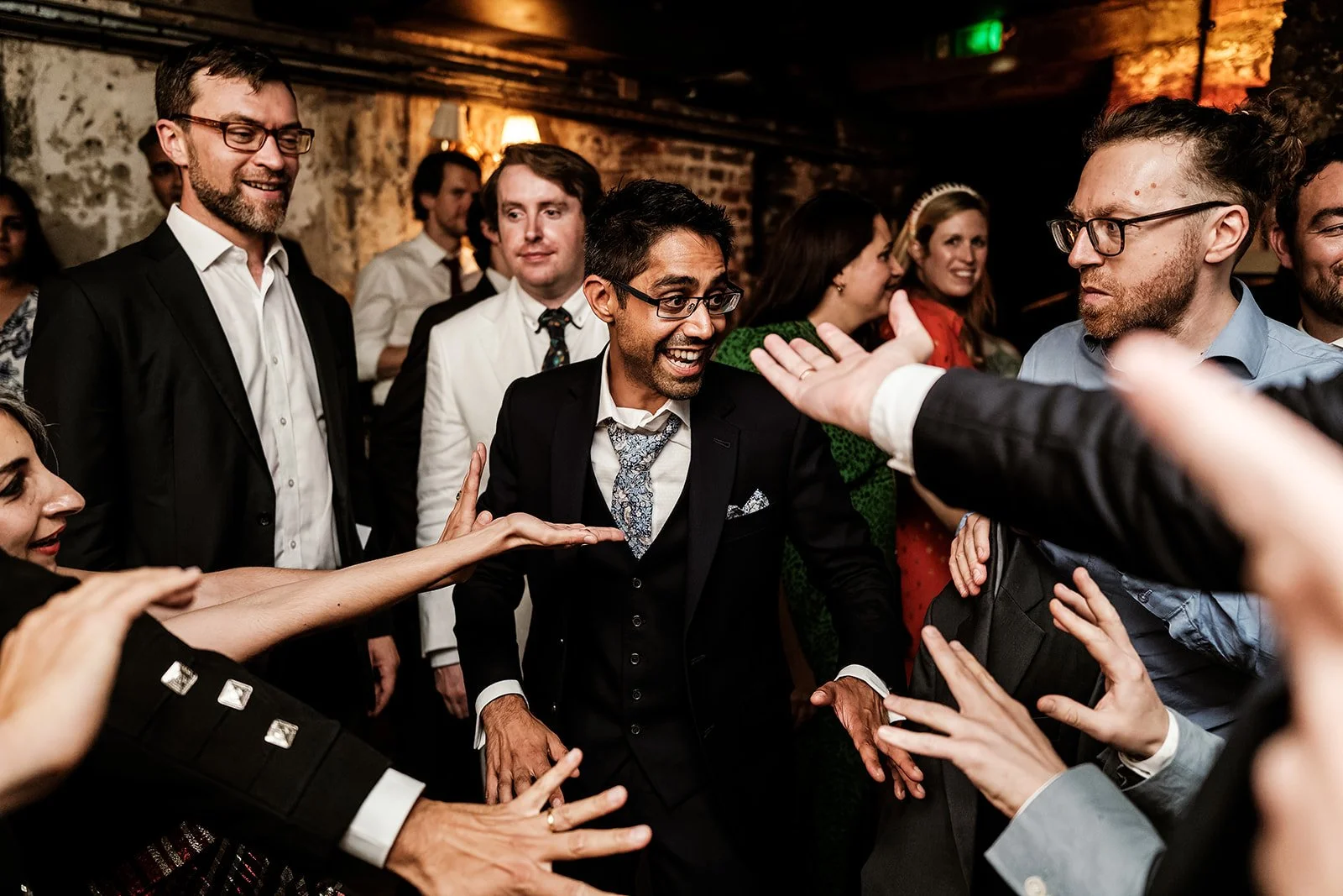 Guests celebrating at Brunswick House wedding — documentary photography by Oliver Holder