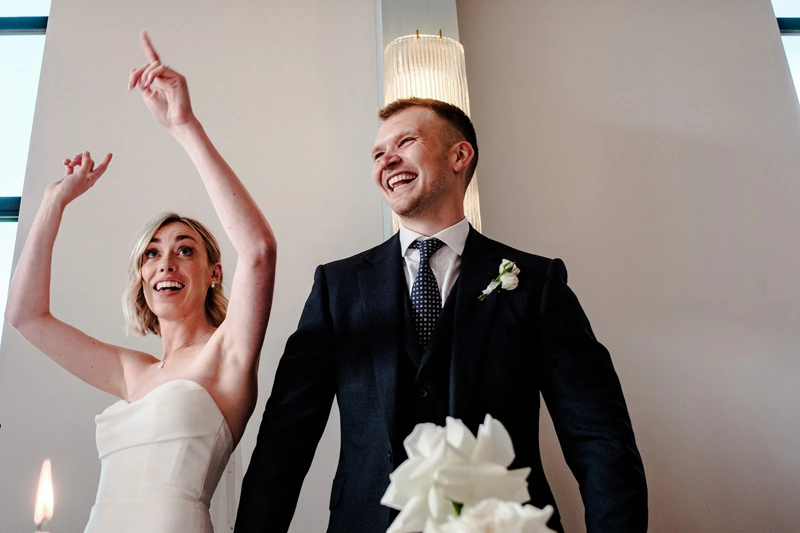 Wedding guests laughing together during the speeches at the Limekiln reception — genuine unguarded reaction