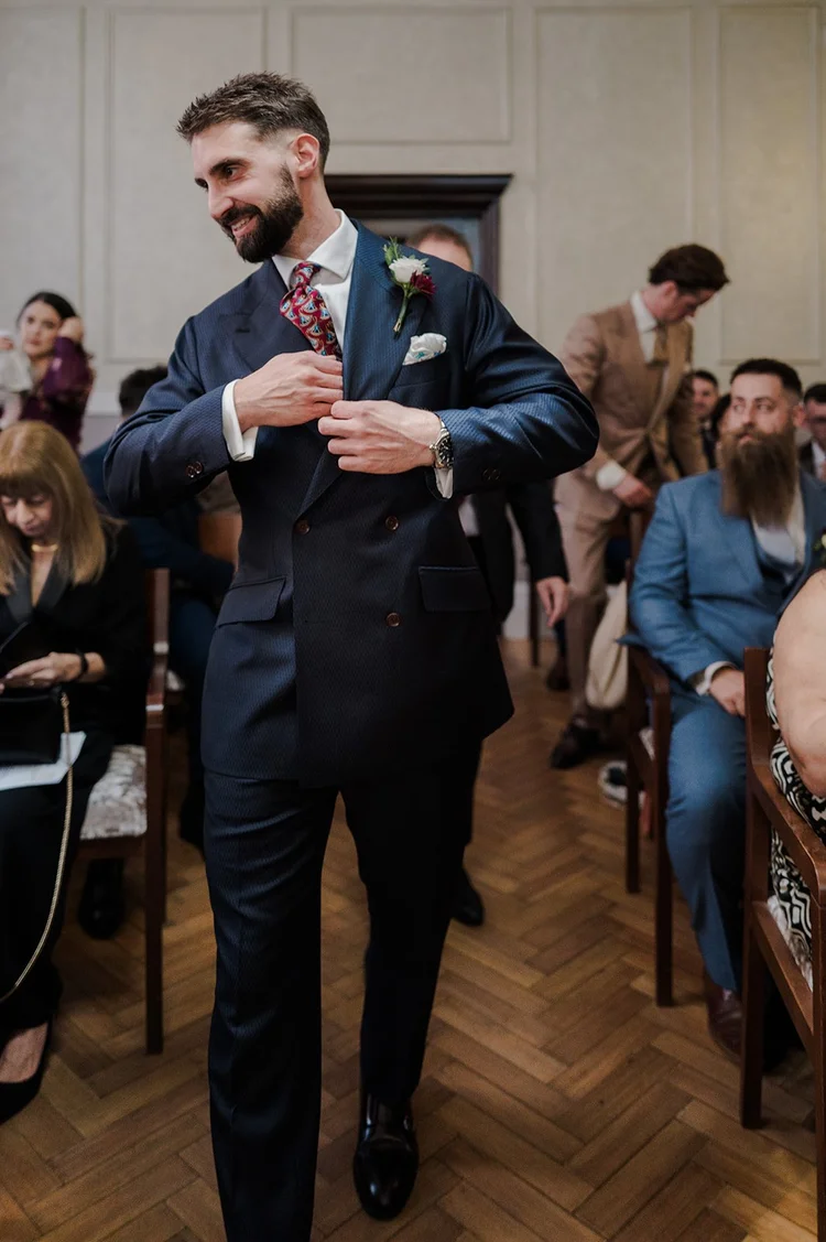 Groom waiting at the front of the ceremony room at Chelsea Old Town Hall