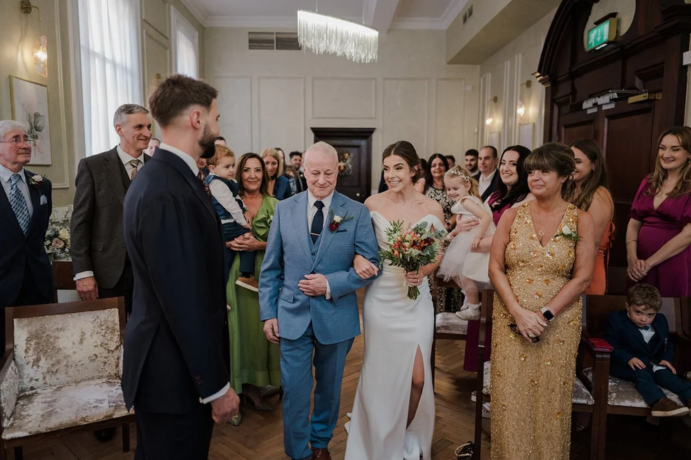 Nat walking down the aisle with her father at Chelsea Town Hall
