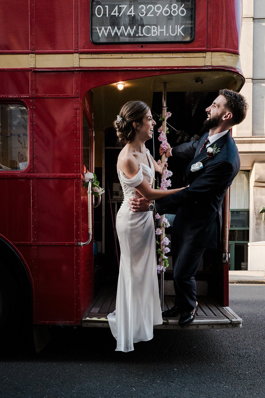 Nat and Josh on the step of the red Routemaster bus