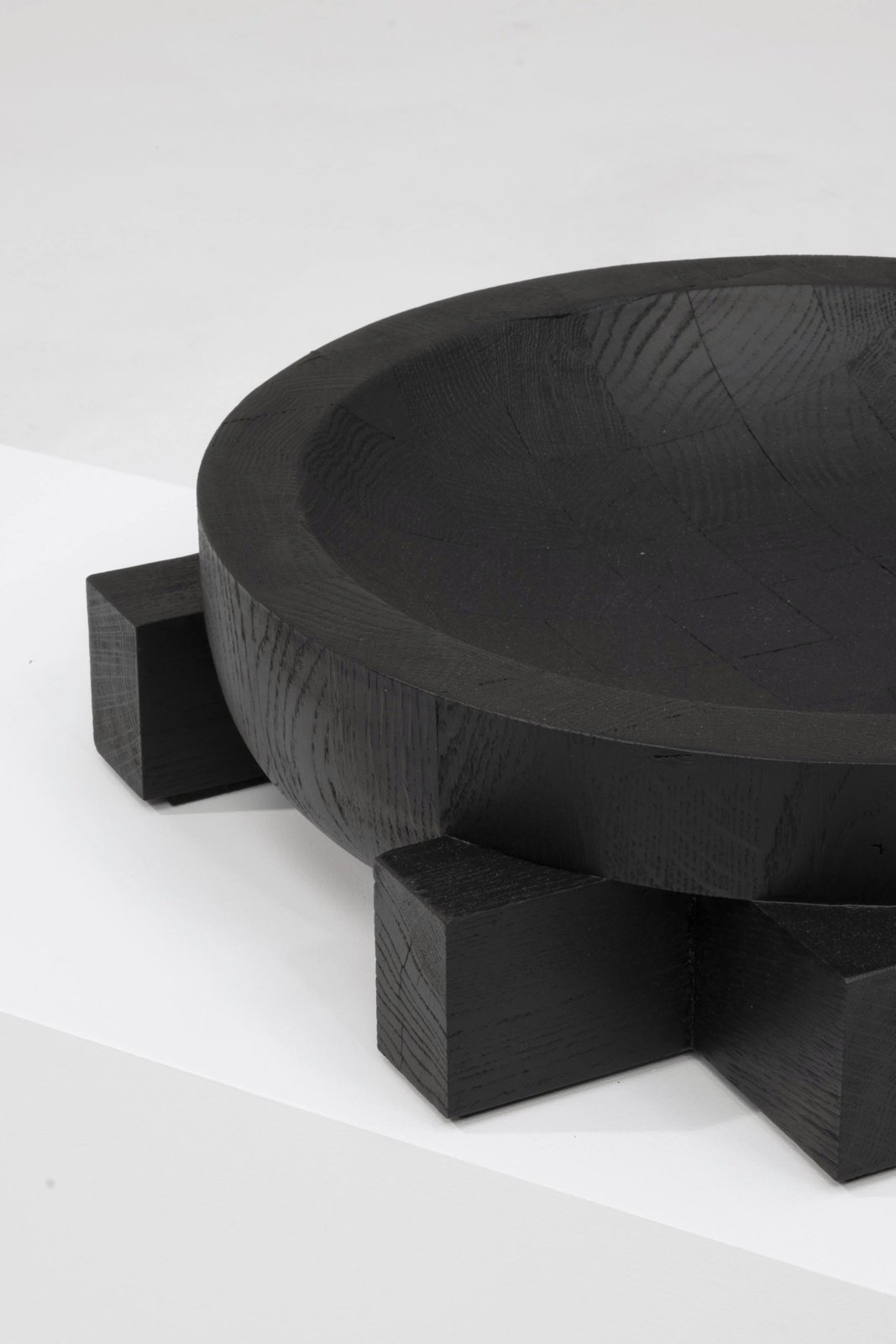Detail of the carved oak rim and cross-shaped support of the Cross Tray by Arno Declercq.