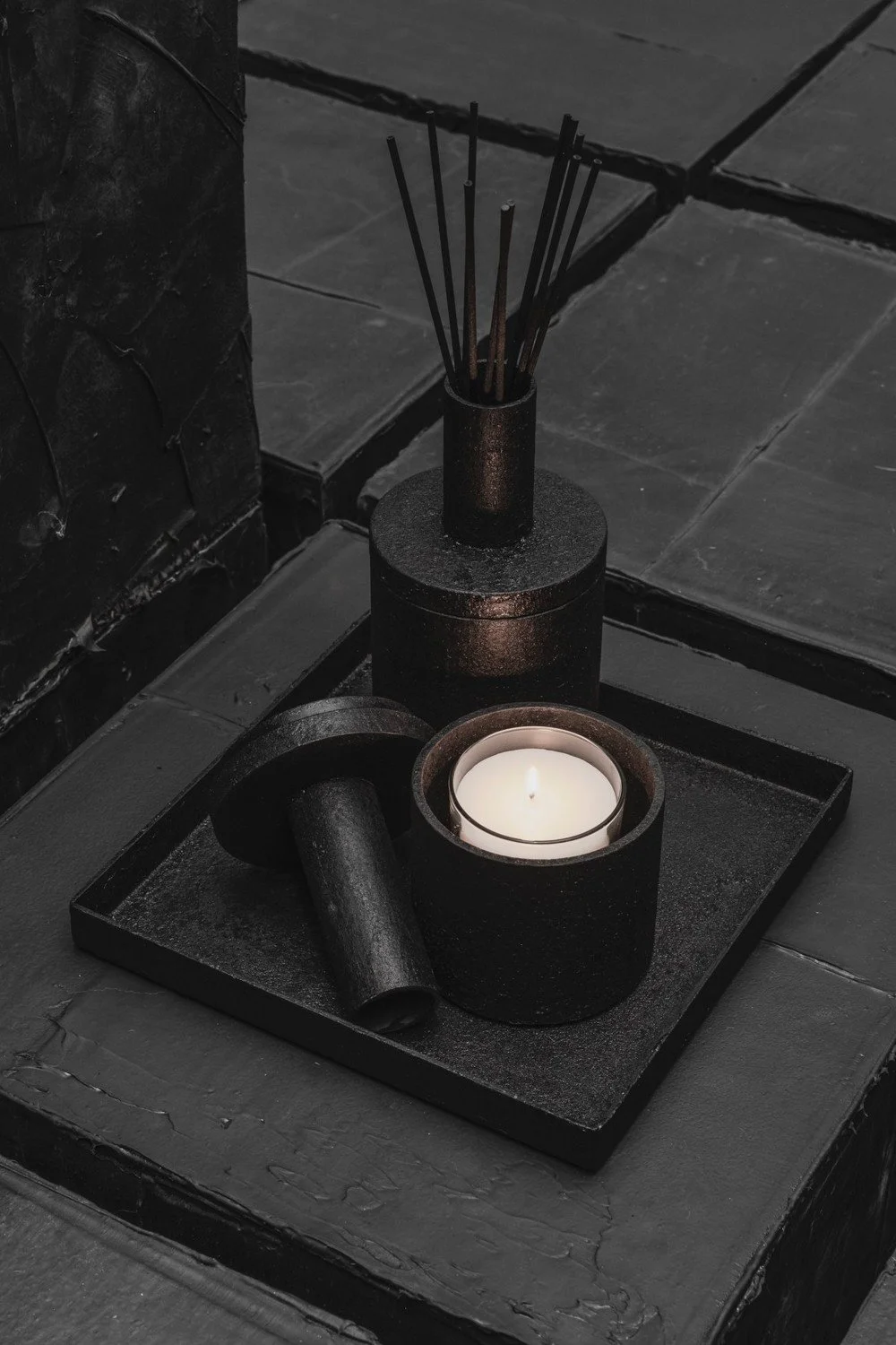 Oxidarium candle and reed diffuser inside their handmade metal containers