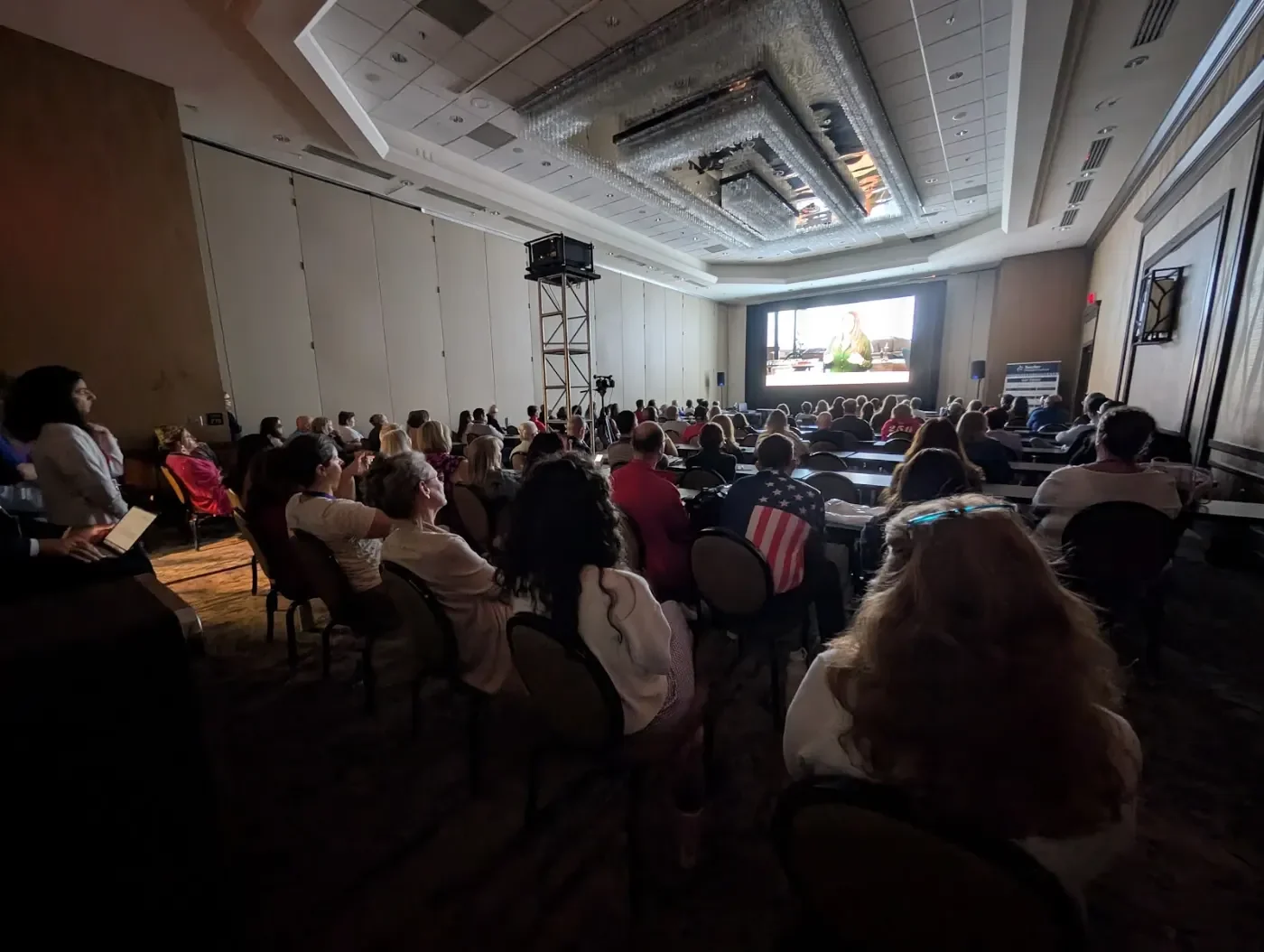 A packed ballroom watches 15 DAYS at the Teachers Summit in Dallas