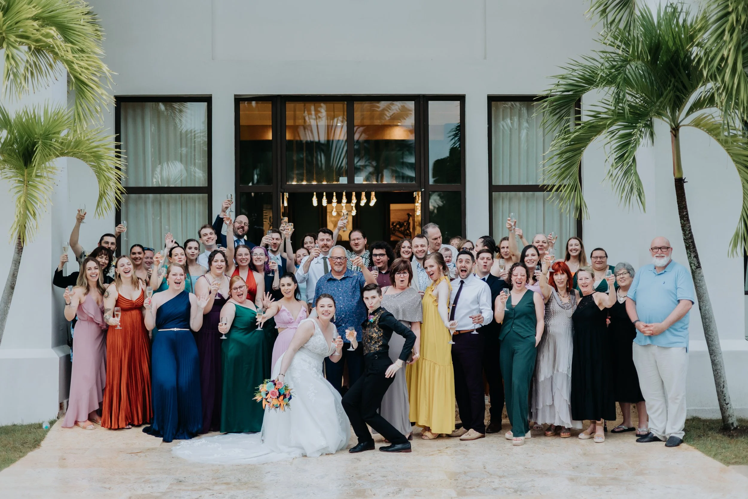 Wedding couple and all their guests celebrating together at a tropical resort