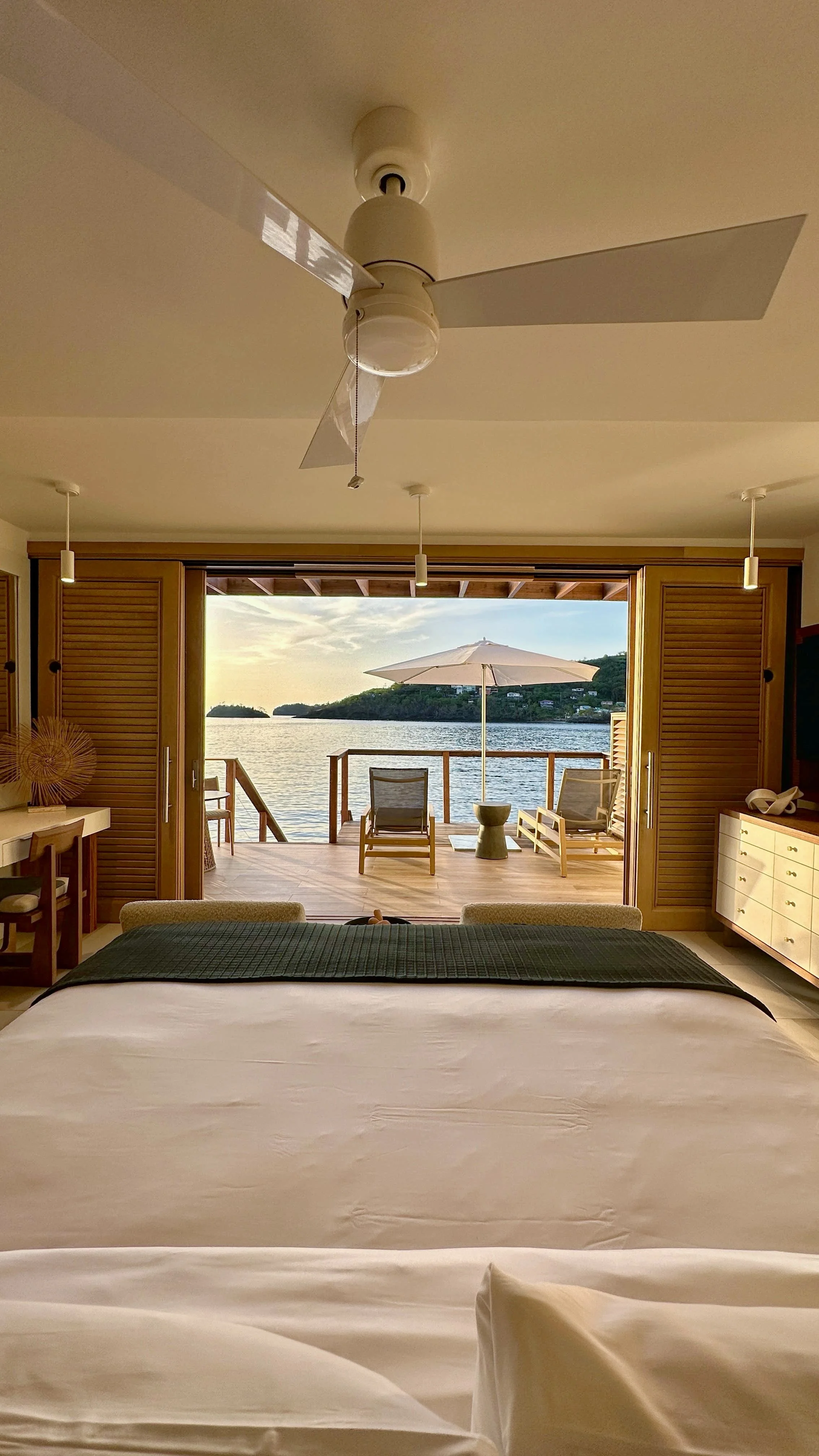 Overwater bungalows with turquoise water at sunset