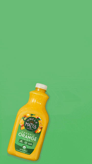 Orange slices bursting from an Uncle Matt's orange juice bottle on green, CPG beverage motion GIF