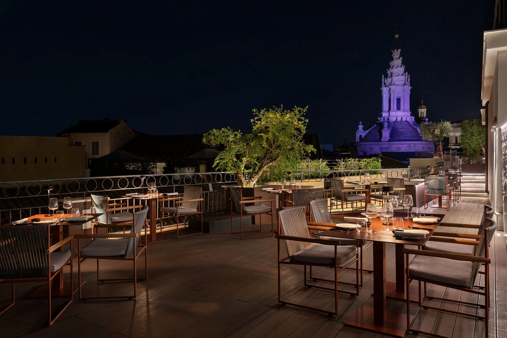 The rooftop terrace at The Pantheon Iconic Rome Hotel in the evening