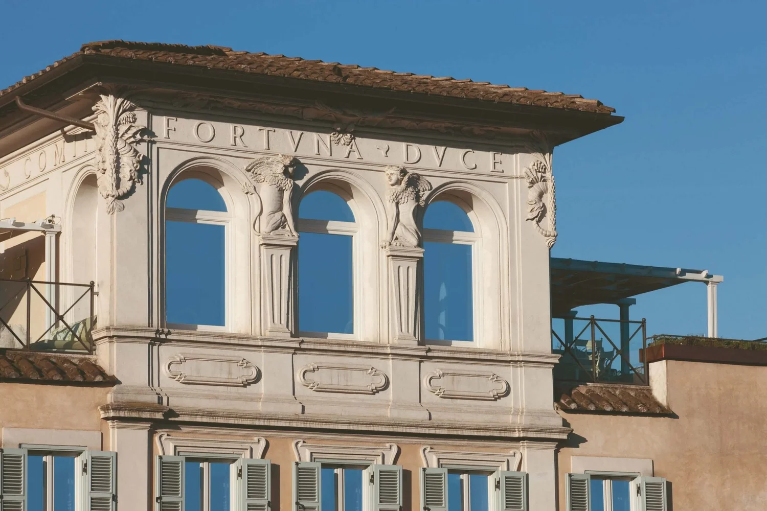 Rooftop loggia with carved caryatids at Palazzo Manfredi