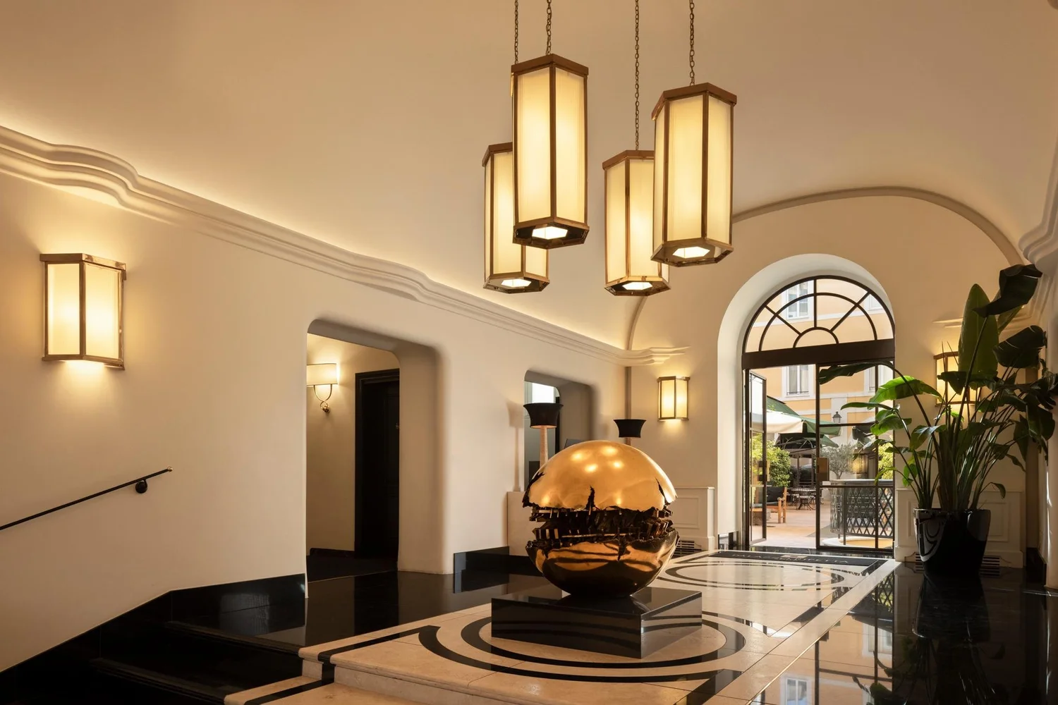 Entrance hall of Palazzo Ripetta with a bronze Pomodoro sphere