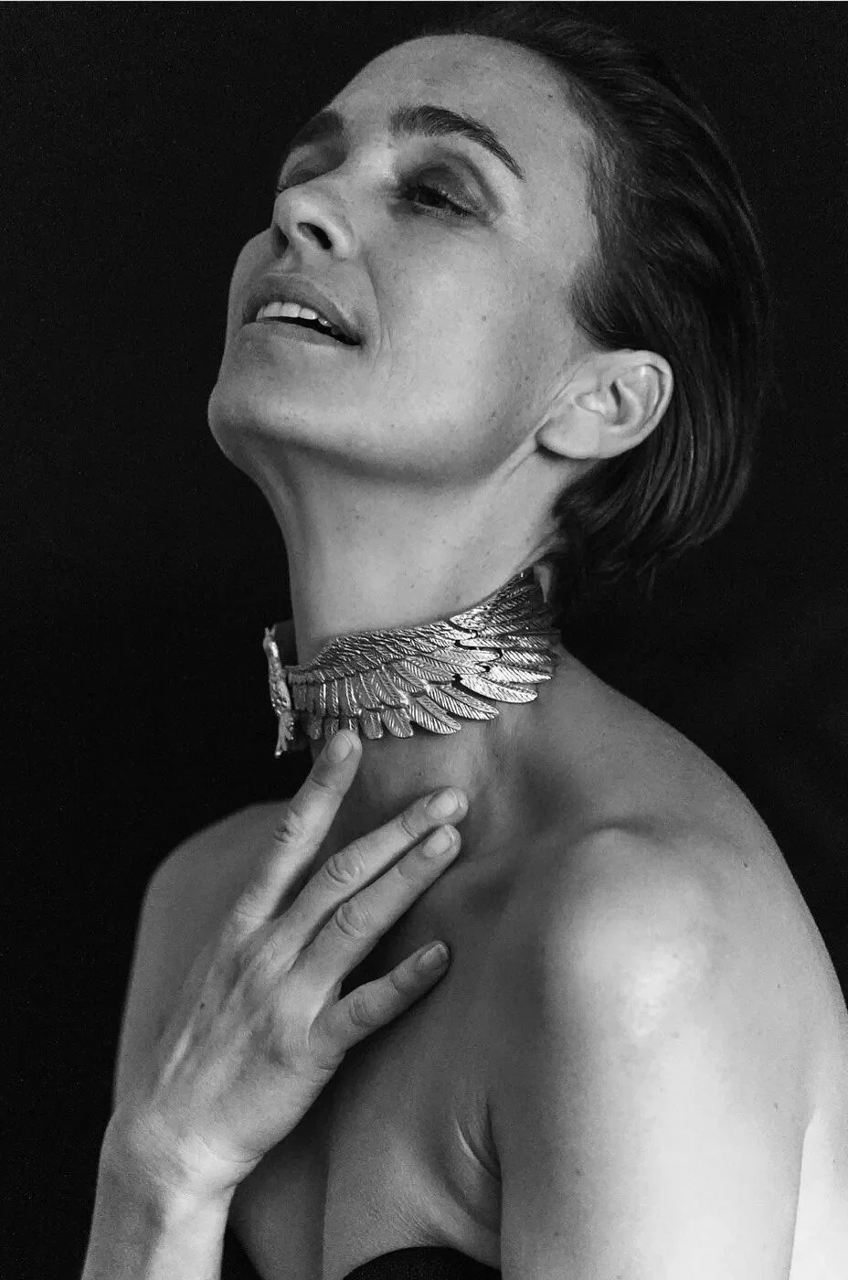 Black and white portrait of a woman wearing a silver wing collar necklace, photographed by Love Society Studios
