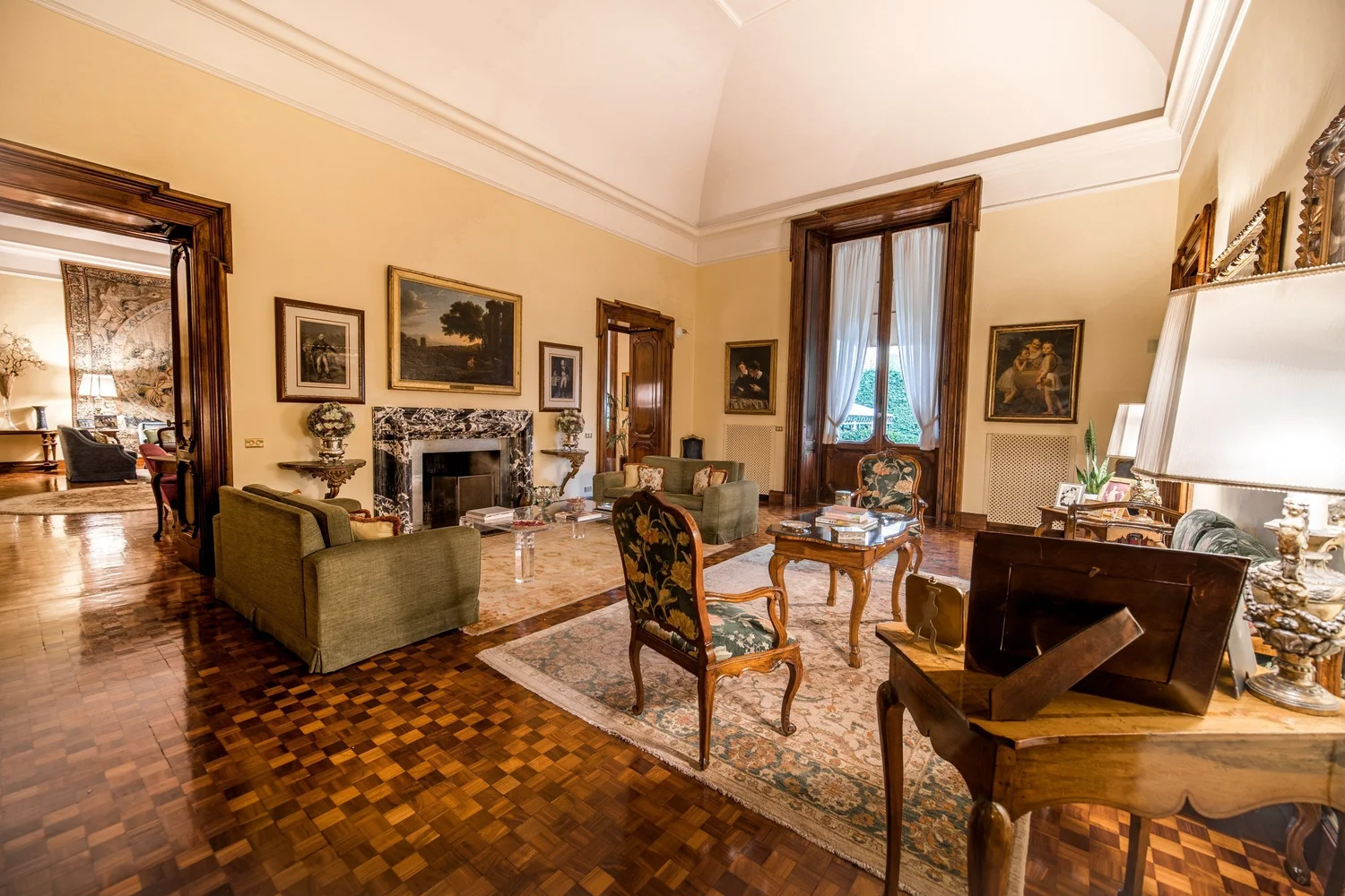 Drawing room at Villa Spalletti Trivelli with a marble fireplace