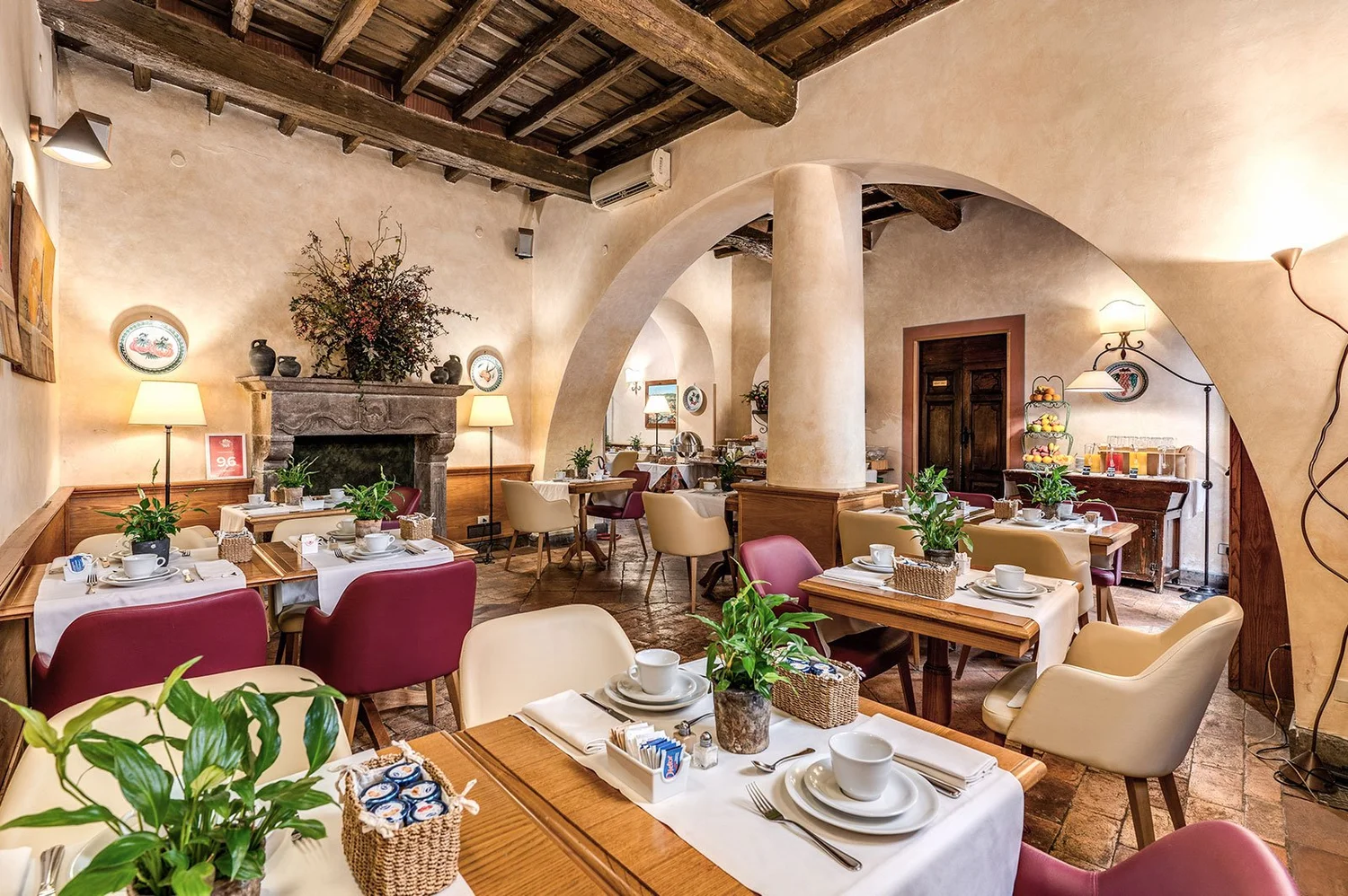 Breakfast room at Hotel Santa Maria with a stone arch and fireplace