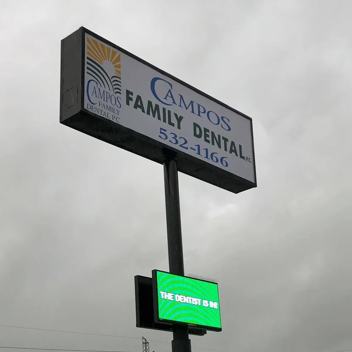 Campos Family Dental pylon sign above an electronic display reading The Dentist Is In.