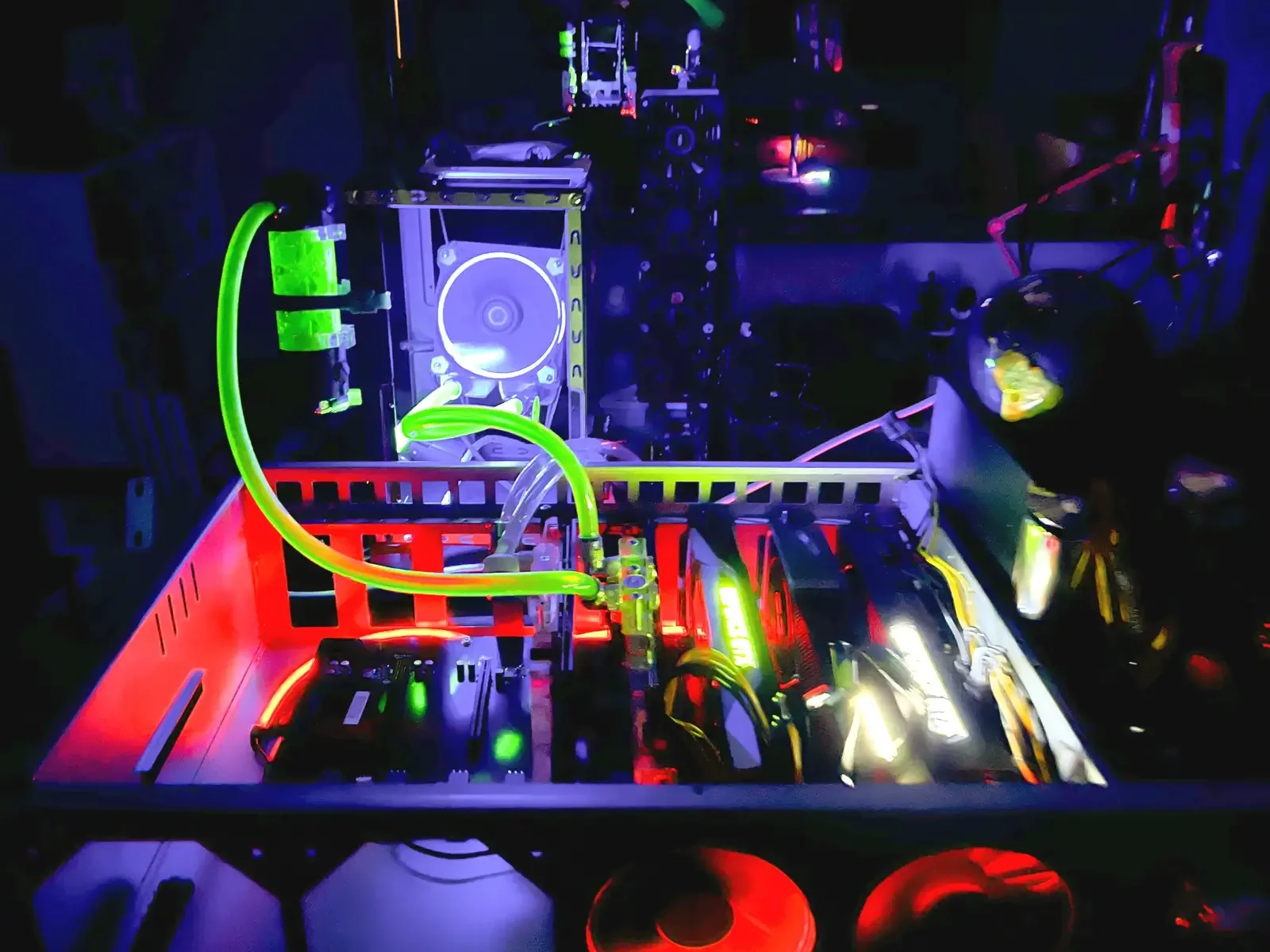 Illuminated open-frame multi-GPU system with green liquid-cooling lines.