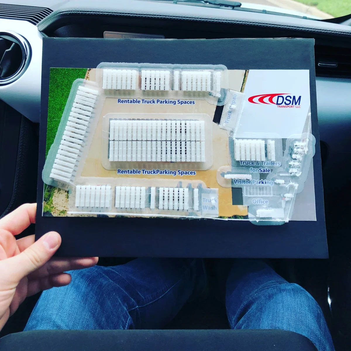 Miniature 3D-printed DSM Transport truck-lot map showing parking rows, office and service areas.