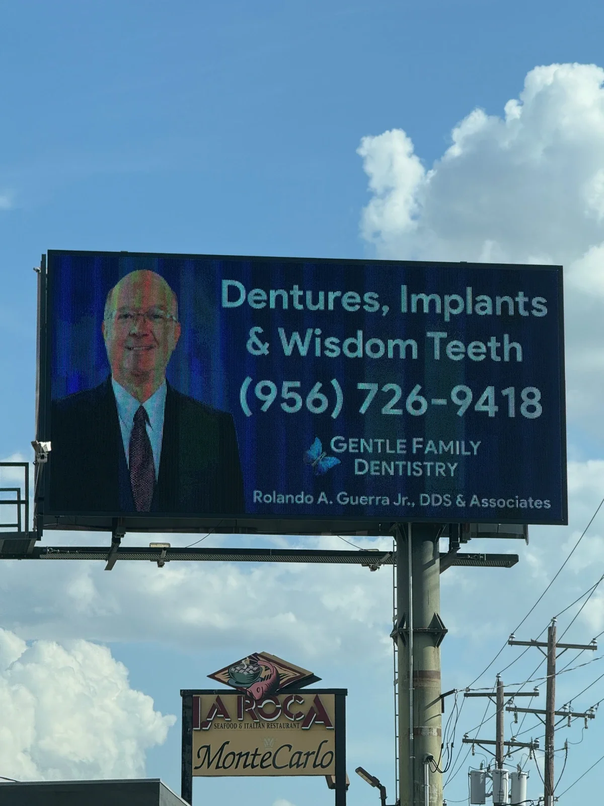 Roadside digital billboard advertising dentures, implants and wisdom-teeth services for Gentle Family Dentistry.