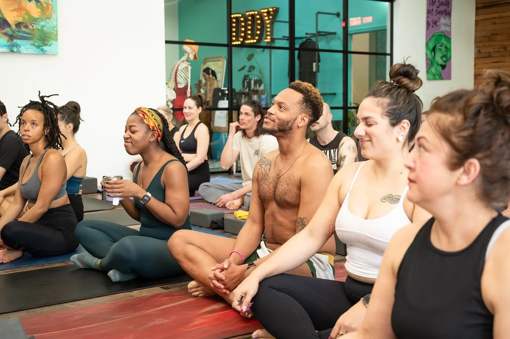 Yoga teacher trainees laughing together during teacher training at Dancing Dogs Yoga in Atlanta