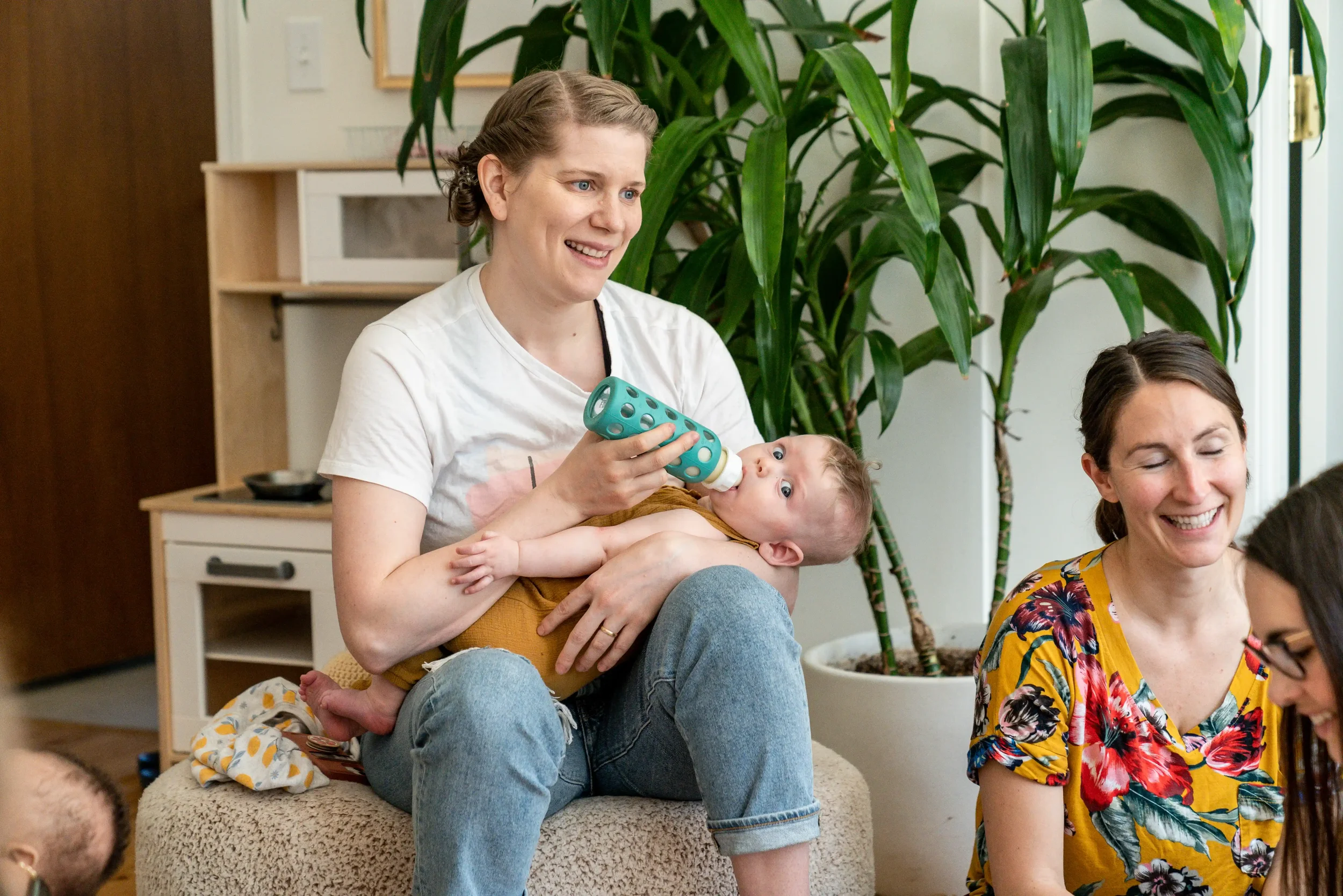 A mother bottle-feeding her baby at the Be Well Baby clinic
