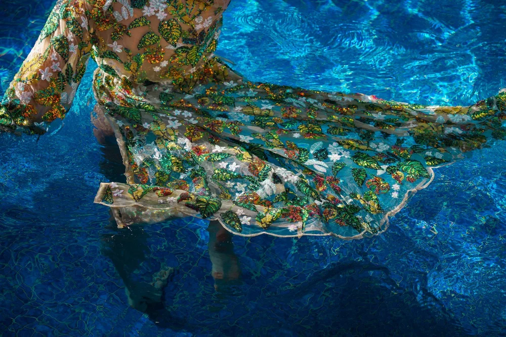 Detail of the Tropical Emerald Kimono spread across blue pool water.