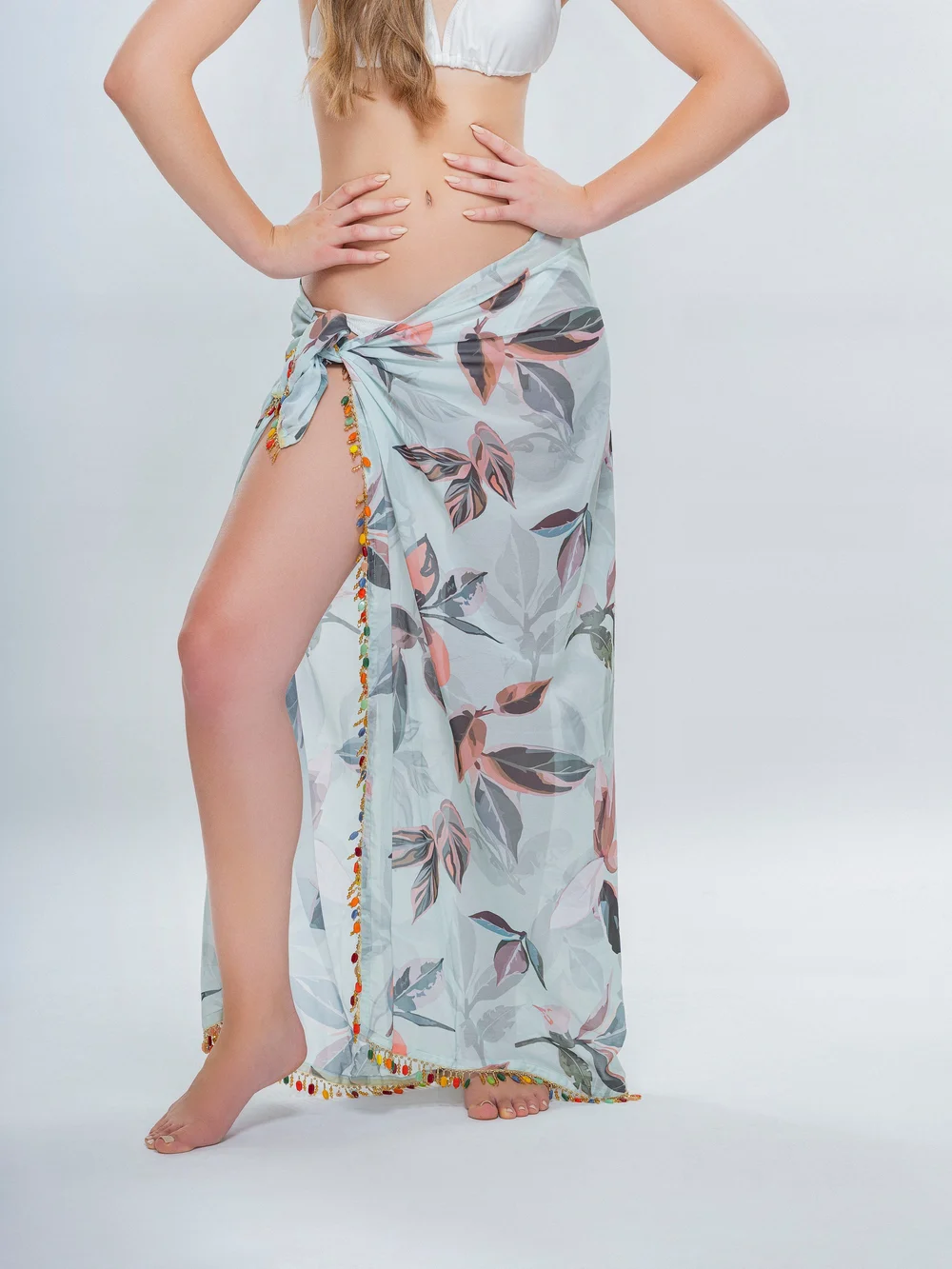 Studio view of the Tahiti Pareo showing the side knot, botanical pattern and decorated hem.
