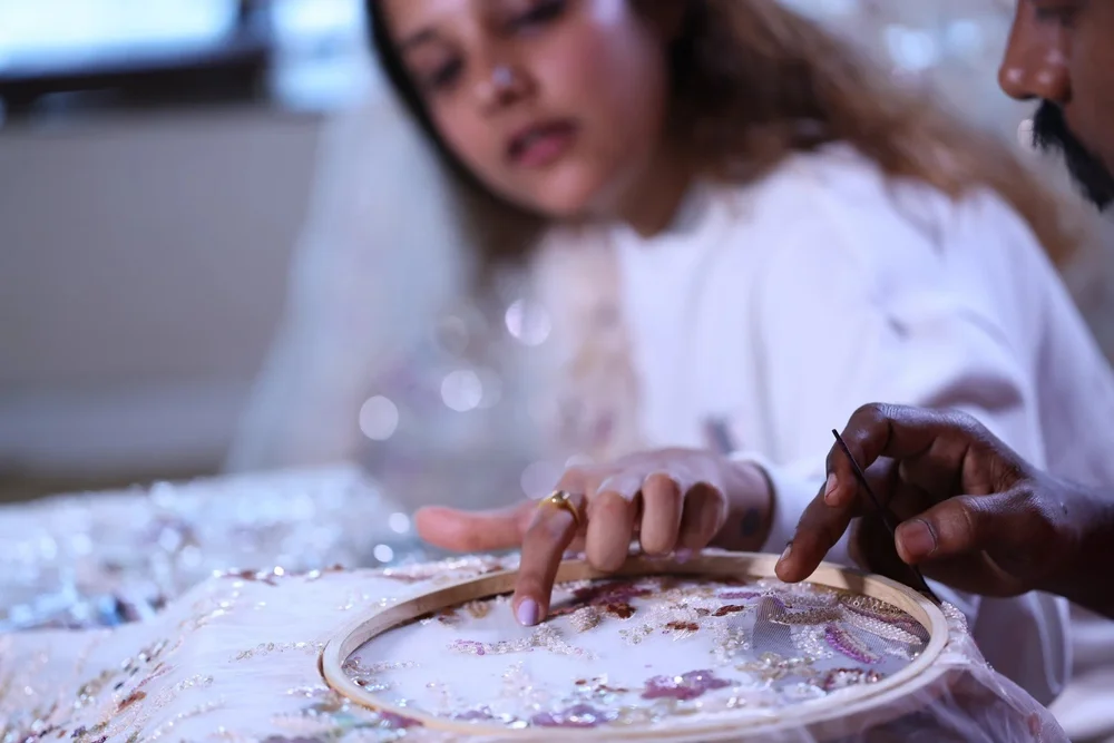 KUMARI artisans working together on the Pink Sapphire Blossom Kaftan.