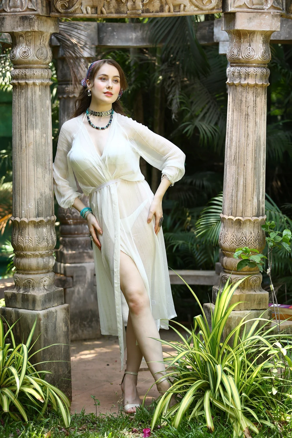 Full-length editorial view of the Maldives Kimono among carved stone pillars.