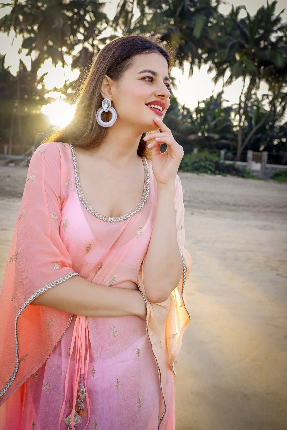 Sunset Rose Kaftan in a closer portrait showing the ombré cloth and embellished neckline.