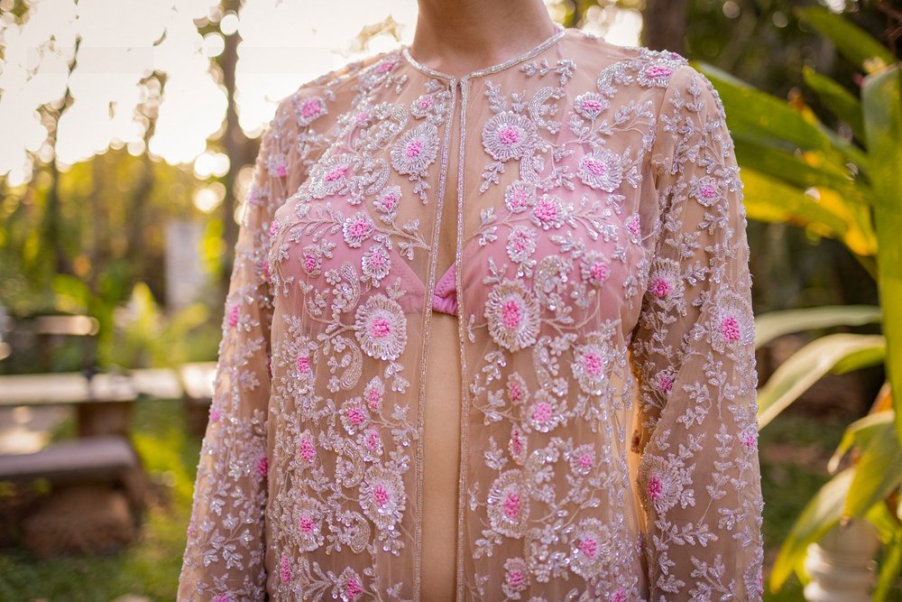Close view of the Daria-i-Noor Sherwani showing its embellished neckline and floral beadwork.