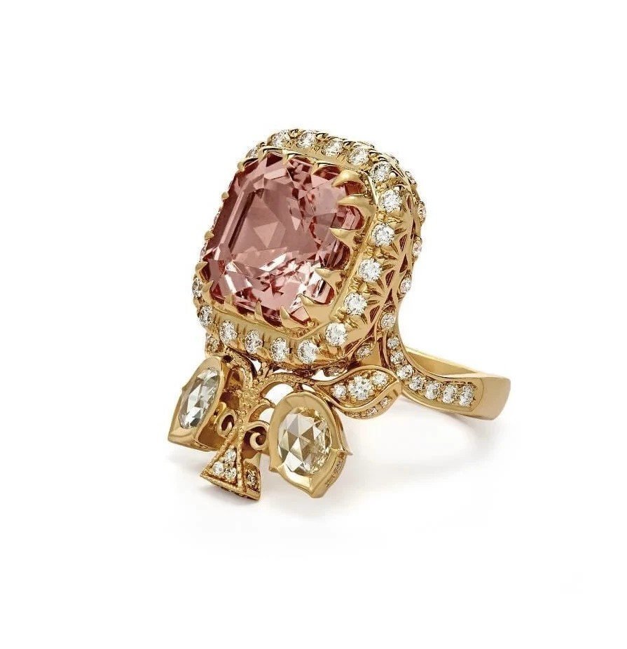 Pink sapphire ring in an ornate gold setting, a jewellery reference for the kaftan.