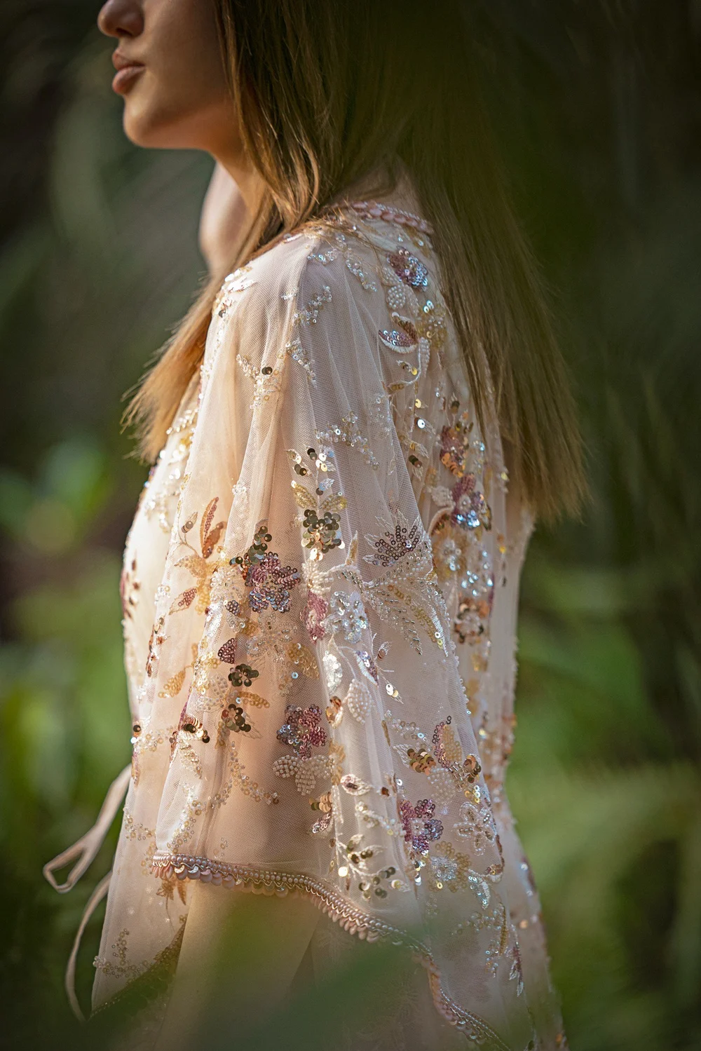 Side view of the Pink Sapphire Blossom Kaftan showing its sheer, embellished sleeve.