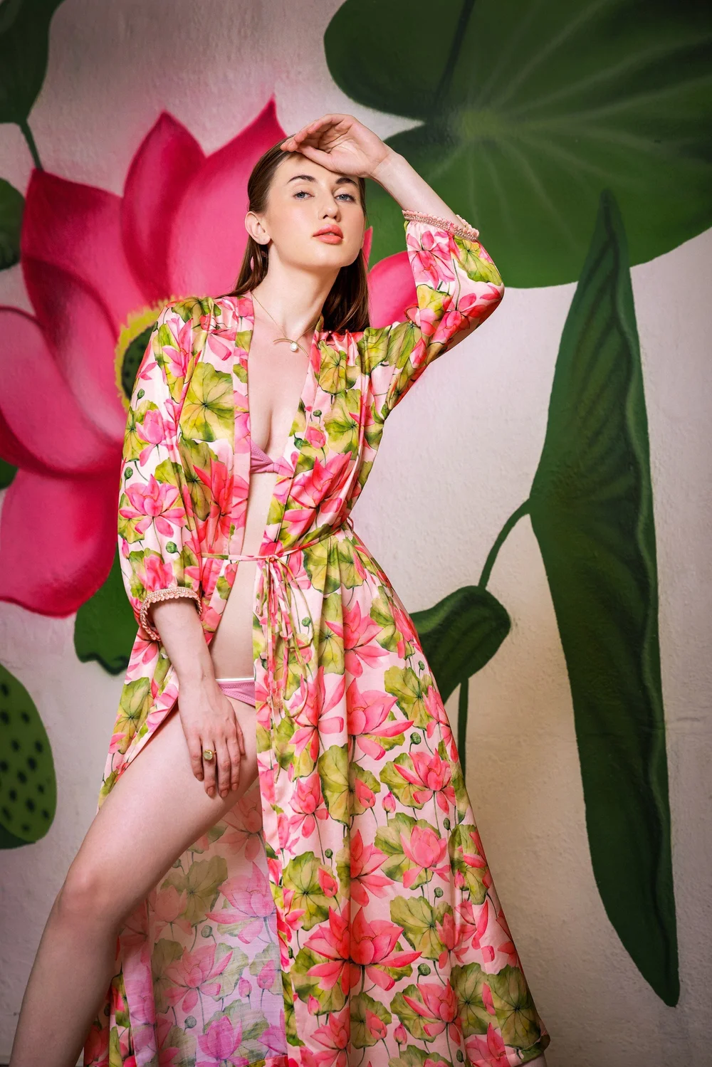 Lotus Radiance Kimono worn beside a painted floral wall.
