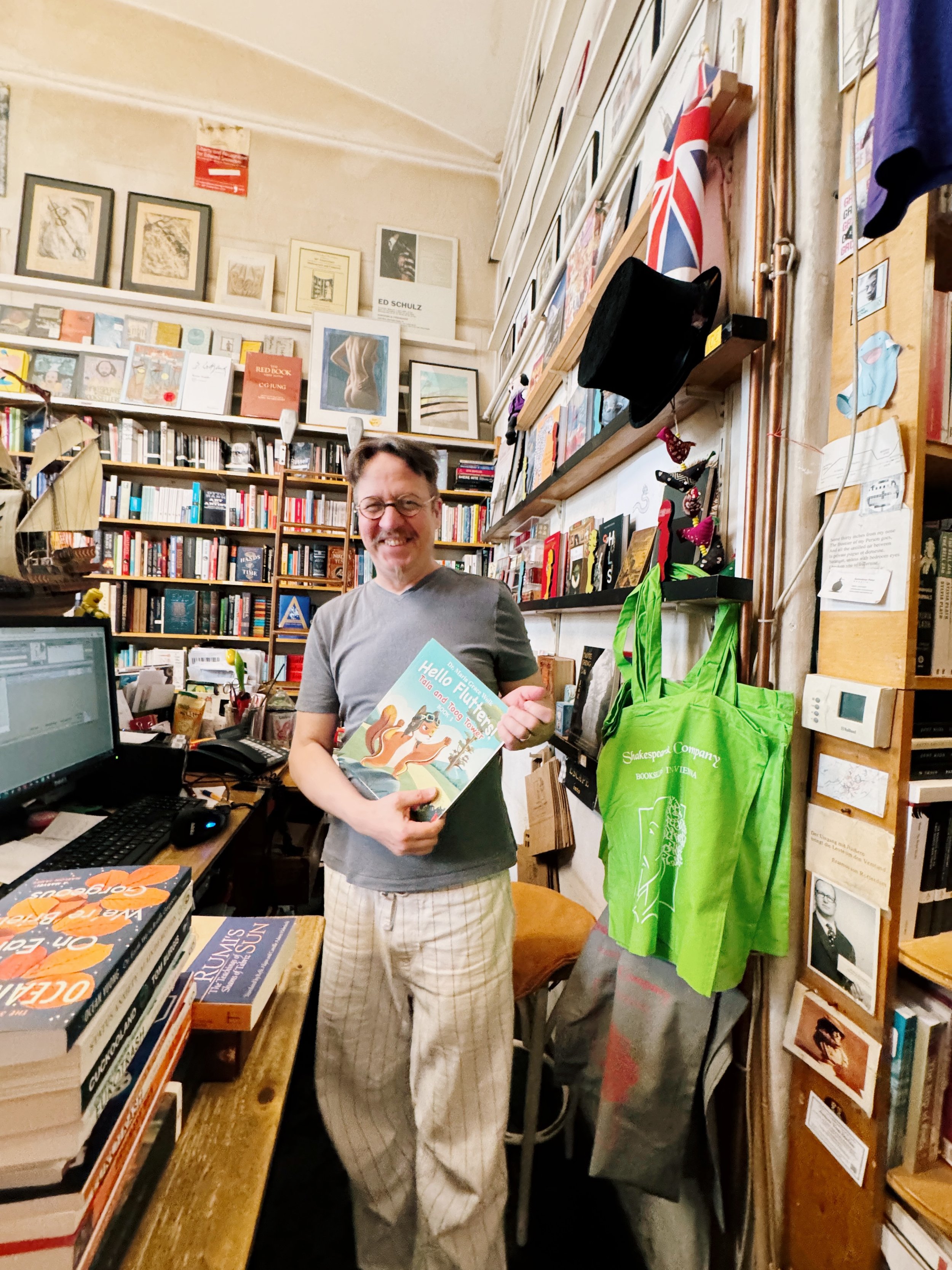 Shakespeare and Company Vienna owner holding Hello Flutters