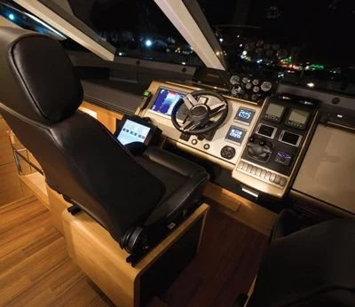 A traditional yacht helm with multiple separate displays and controls