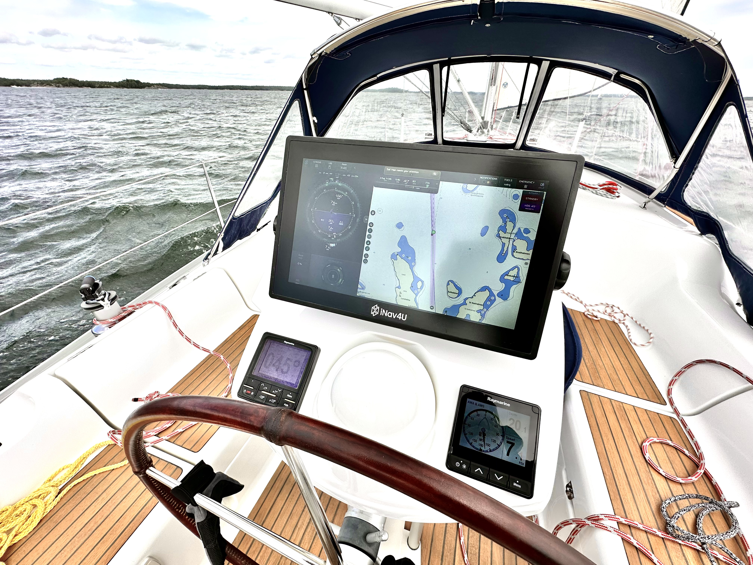Zora at a daylight helm alongside the existing instruments and wheel