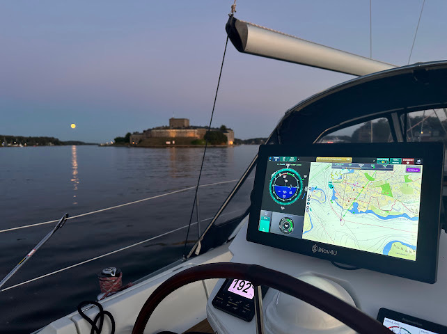 Zora at the helm of a sailboat