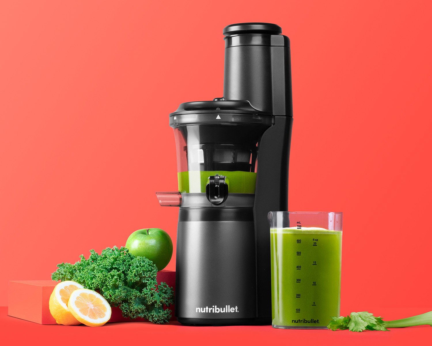 nutribullet slow juicer on coral background