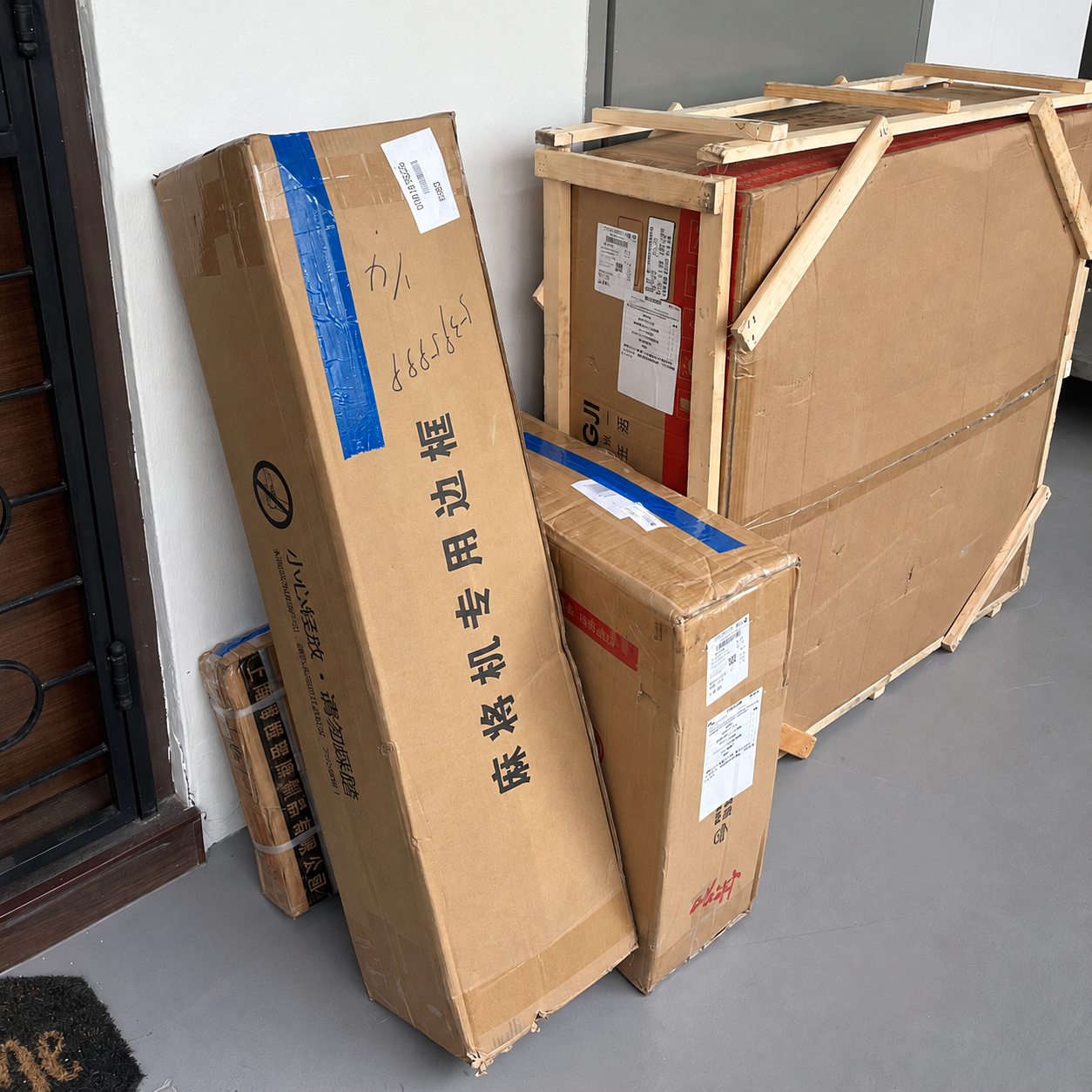 Boxed furniture and wooden shipping crates delivered to a home