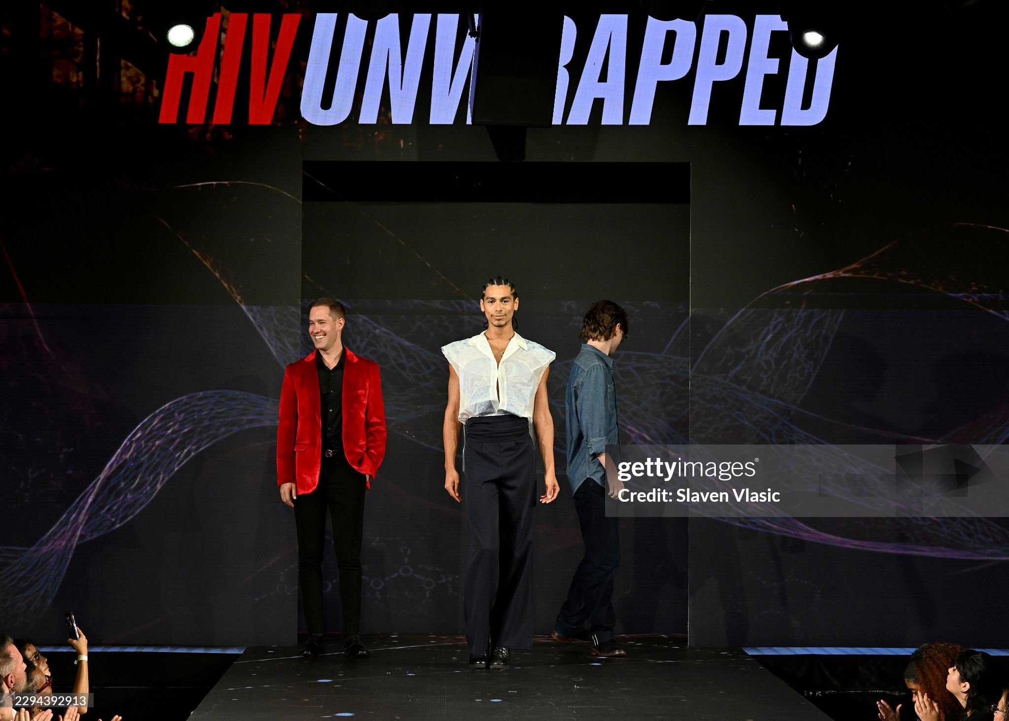 REACH Program Manager Adam Ward, in a red blazer at left, on the HIV Unwrapped 2.0 runway with his creative collaborators