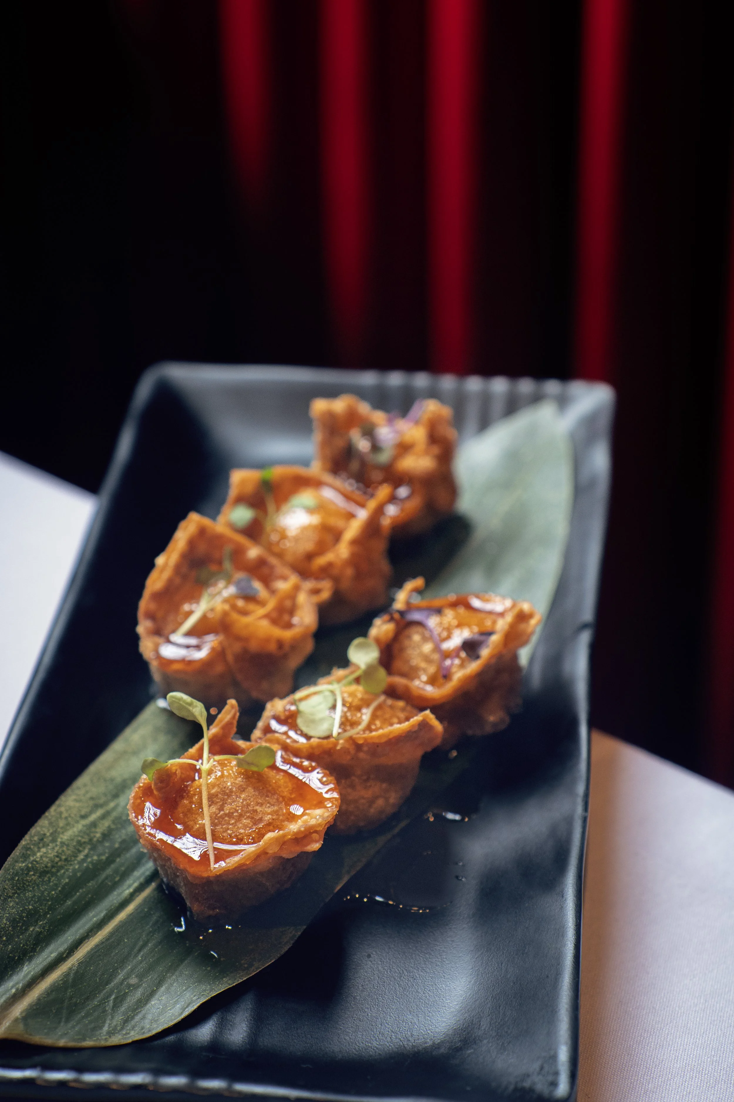 Plated dish at Panda Harlem with moody evening lighting