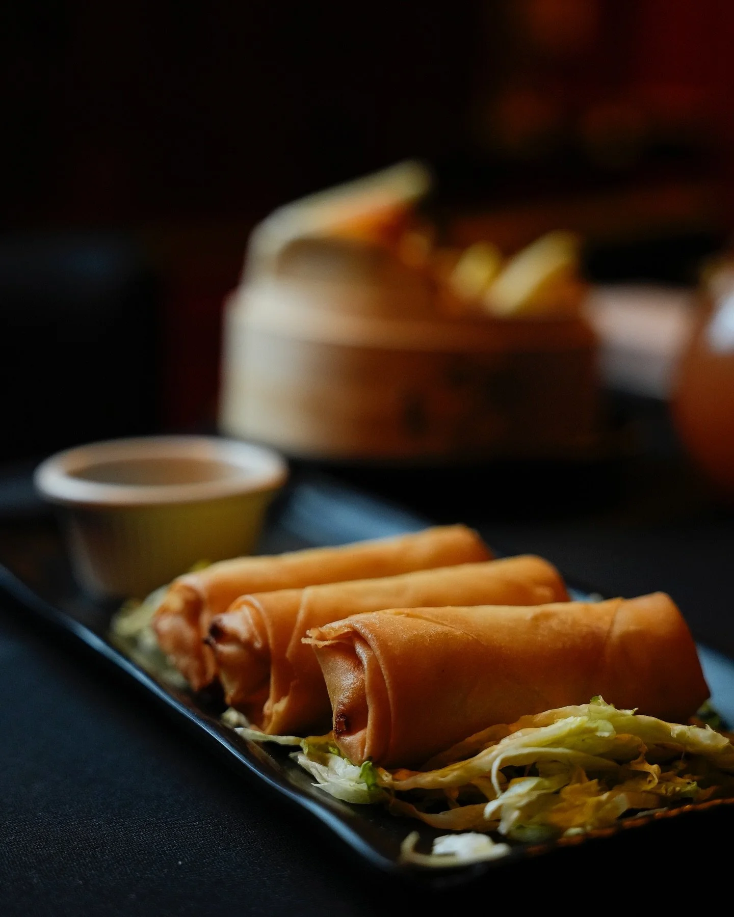 Shareable plates including dumplings, bao buns and scallion pancakes at Panda Harlem