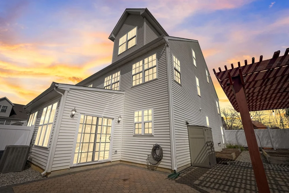 Twilight photograph of a Middletown, Delaware home with pergola