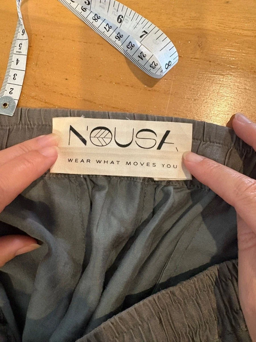 NOUSA woven waistband label on a garment in progress