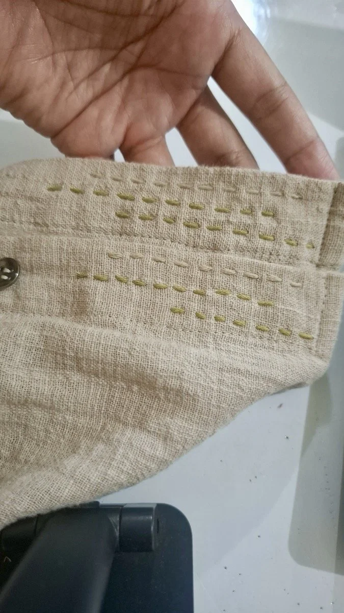 Hand running-stitch detail on natural linen, Nousa Concept